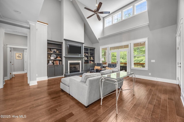 137 Summerset Lndg, Hampstead, NC 28443 - living area featuring a fireplace, a high ceiling, ceiling fan, and dark wood finished floors