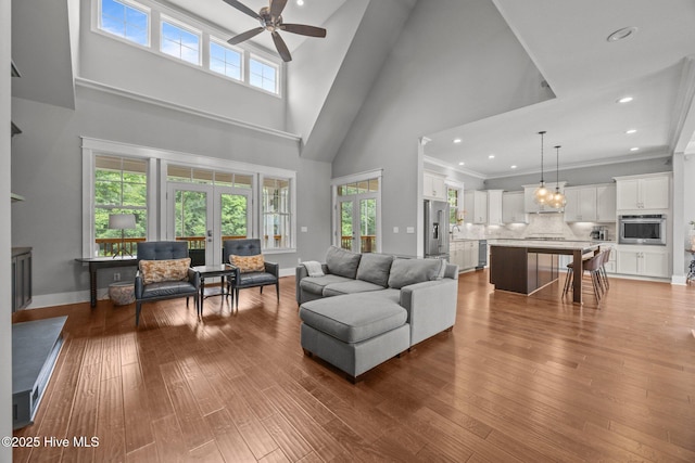 137 Summerset Lndg, Hampstead, NC 28443 - living area with ceiling fan, a towering ceiling, french doors, healthy amount of natural light, and hardwood / wood-style floors