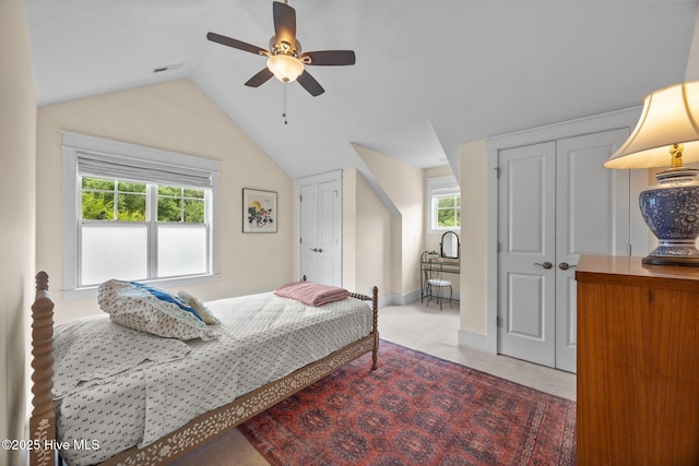 137 Summerset Lndg, Hampstead, NC 28443 - bedroom featuring two closets, vaulted ceiling, multiple windows, carpet, and a ceiling fan