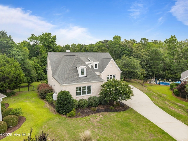 137 Summerset Lndg, Hampstead, NC 28443 - view of side of home featuring driveway, stucco siding, roof with shingles, and a chimney