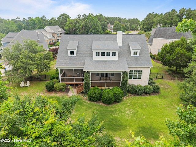 137 Summerset Lndg, Hampstead, NC 28443 - rear view of house with a sunroom, a chimney, and roof with shingles