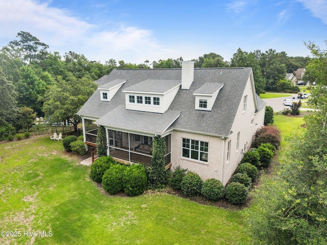 137 Summerset Lndg, Hampstead, NC 28443 - back of property with a sunroom, a chimney, and roof with shingles