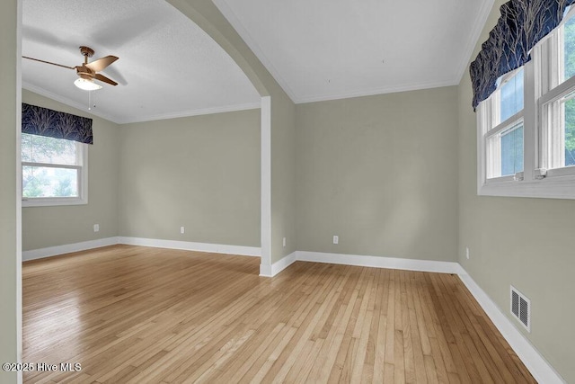 408 N 25th St, Wilmington, NC 28405 - empty room with light wood finished floors, arched walkways, ceiling fan, crown molding, and baseboards