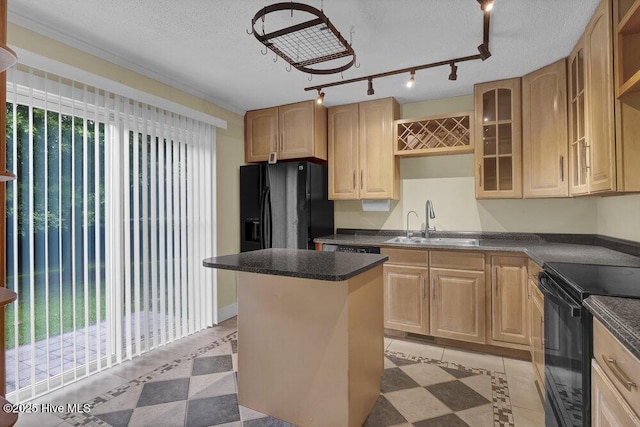 408 N 25th St, Wilmington, NC 28405 - kitchen featuring a sink, black appliances, light tile patterned flooring, a kitchen island, and a textured ceiling