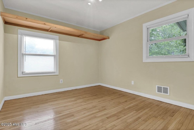 408 N 25th St, Wilmington, NC 28405 - empty room featuring healthy amount of natural light, light wood-type flooring, baseboards, and crown molding