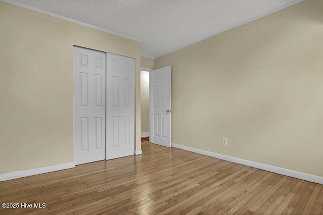 408 N 25th St, Wilmington, NC 28405 - unfurnished bedroom featuring baseboards, wood finished floors, ornamental molding, and a closet