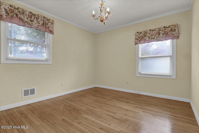 408 N 25th St, Wilmington, NC 28405 - unfurnished room with plenty of natural light, wood-type flooring, a chandelier, baseboards, and ornamental molding