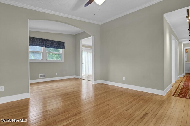408 N 25th St, Wilmington, NC 28405 - spare room featuring arched walkways, light wood-style floors, ceiling fan, crown molding, and baseboards