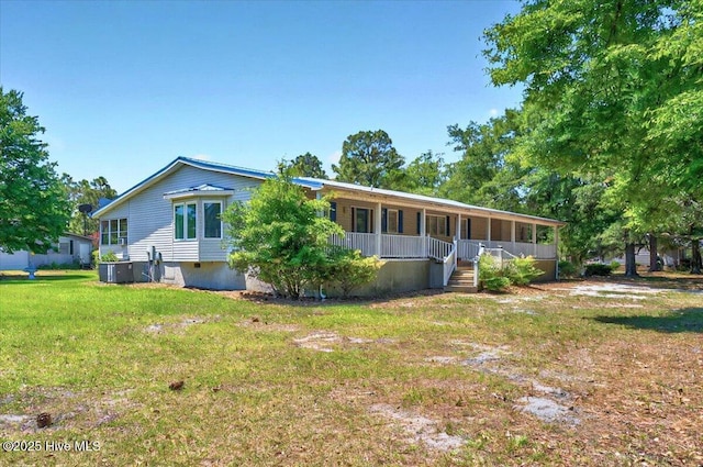 5685 Watts Rd SW, Ocean Isle Beach, NC 28469 - view of front of home featuring covered porch, a front lawn, and central AC