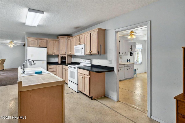 5685 Watts Rd SW, Ocean Isle Beach, NC 28469 - kitchen with white appliances, a ceiling fan, a sink, and a textured ceiling