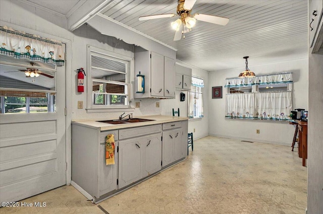5685 Watts Rd SW, Ocean Isle Beach, NC 28469 - kitchen featuring a sink, ceiling fan, light flooring, light countertops, and ornamental molding