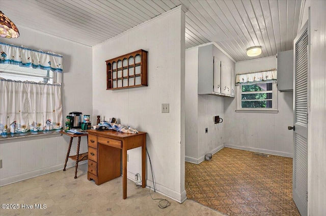 5685 Watts Rd SW, Ocean Isle Beach, NC 28469 - washroom featuring light flooring, hookup for an electric dryer, wood ceiling, wooden walls, and cabinet space