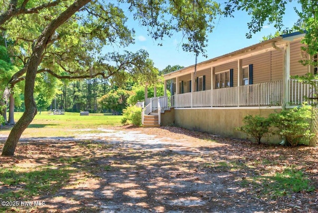 5685 Watts Rd SW, Ocean Isle Beach, NC 28469 - view of yard featuring covered porch
