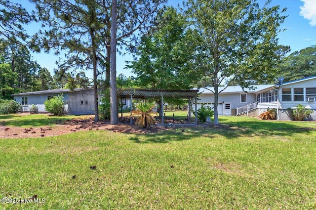 5685 Watts Rd SW, Ocean Isle Beach, NC 28469 - view of green lawn featuring a garage
