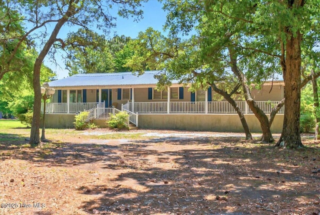 5685 Watts Rd SW, Ocean Isle Beach, NC 28469 - view of front facade with covered porch and metal roof