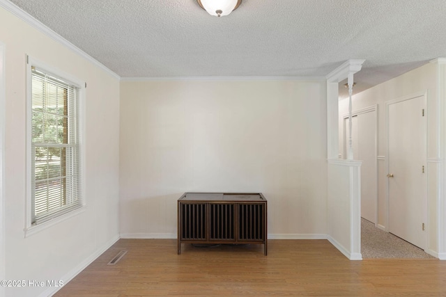 263 La Grange Rd, La Grange, NC 28551 - empty room with wood finished floors, a textured ceiling, crown molding, baseboards, and radiator