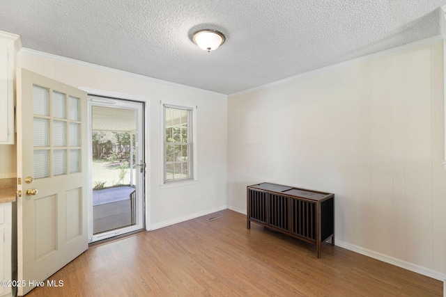 263 La Grange Rd, La Grange, NC 28551 - empty room featuring crown molding, a textured ceiling, light wood-style flooring, and baseboards