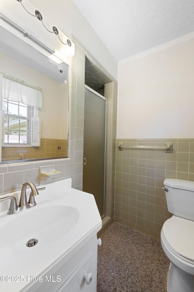 263 La Grange Rd, La Grange, NC 28551 - bathroom featuring tile walls, toilet, vanity, a shower stall, and a textured ceiling
