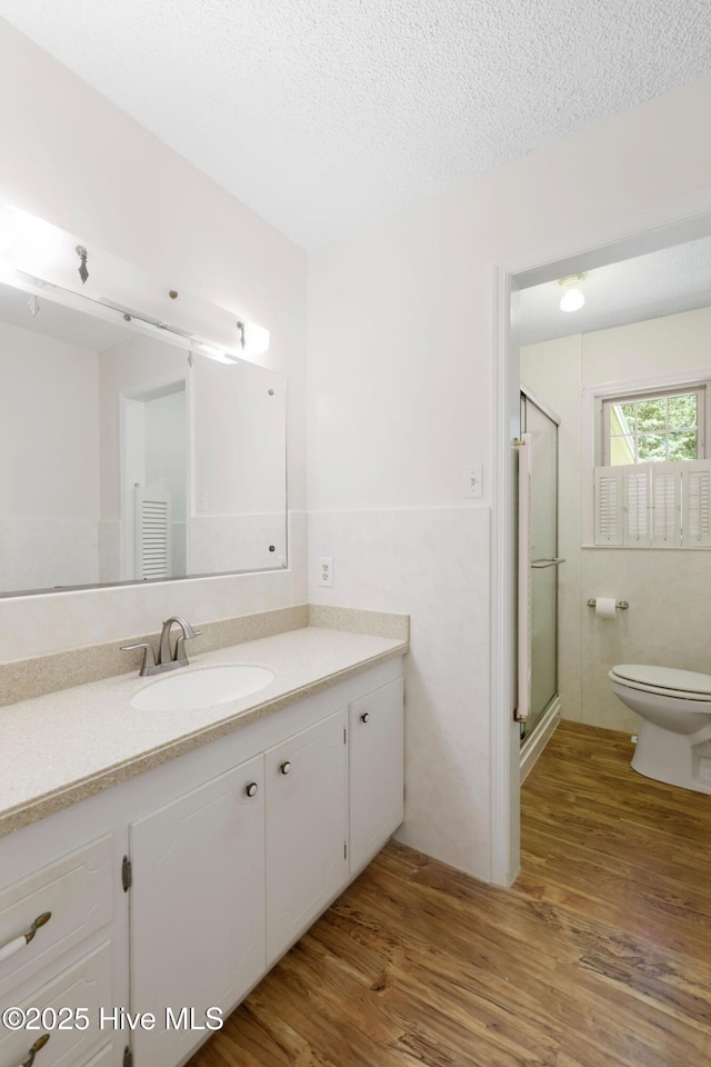 263 La Grange Rd, La Grange, NC 28551 - full bathroom featuring toilet, vanity, wood finished floors, a shower stall, and a textured ceiling