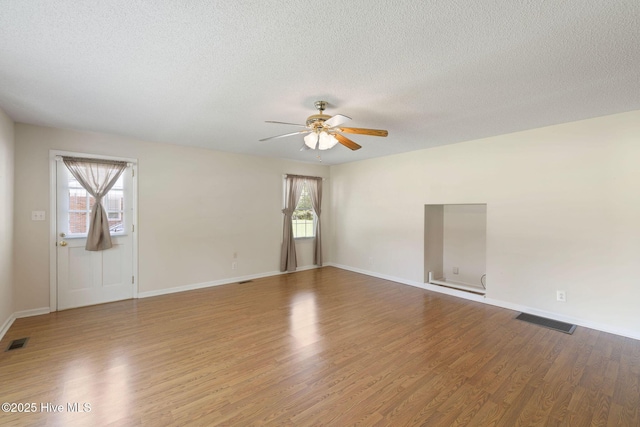 263 La Grange Rd, La Grange, NC 28551 - empty room featuring ceiling fan, wood finished floors, a textured ceiling, and baseboards