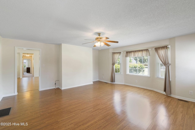 263 La Grange Rd, La Grange, NC 28551 - unfurnished room with ceiling fan, a textured ceiling, wood finished floors, and baseboards