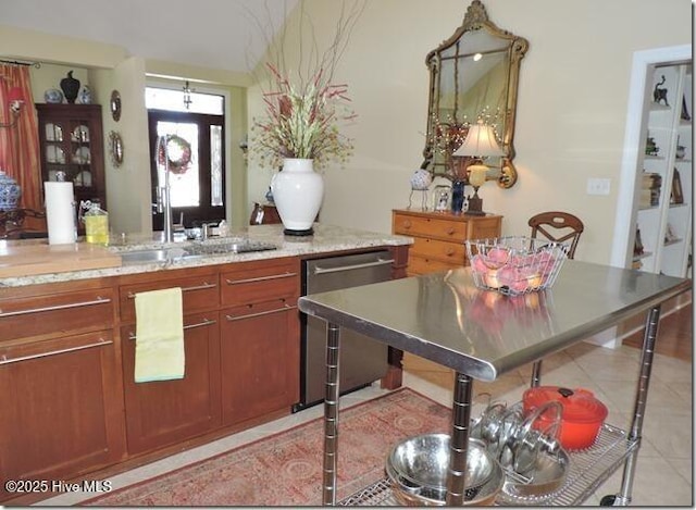 110 E Blalock Rd, Lucama, NC 27851 - kitchen with stainless steel dishwasher, light tile patterned flooring, and light stone counters