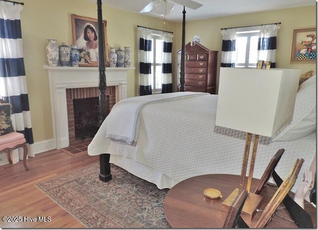 110 E Blalock Rd, Lucama, NC 27851 - bedroom featuring wood finished floors and a brick fireplace