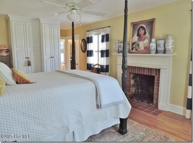 110 E Blalock Rd, Lucama, NC 27851 - bedroom featuring wood finished floors, a fireplace, baseboards, and a ceiling fan