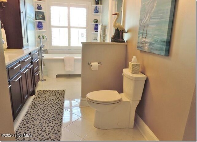 110 E Blalock Rd, Lucama, NC 27851 - bathroom with a freestanding tub, toilet, vanity, tile patterned flooring, and baseboards