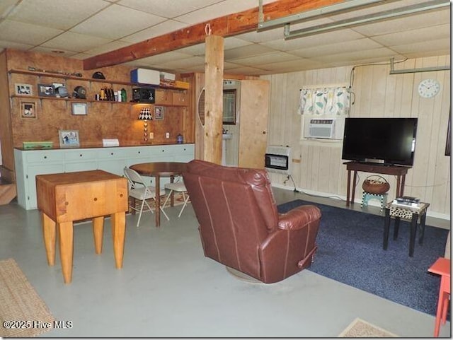 110 E Blalock Rd, Lucama, NC 27851 - living room with a drop ceiling, wood walls, heating unit, and concrete floors