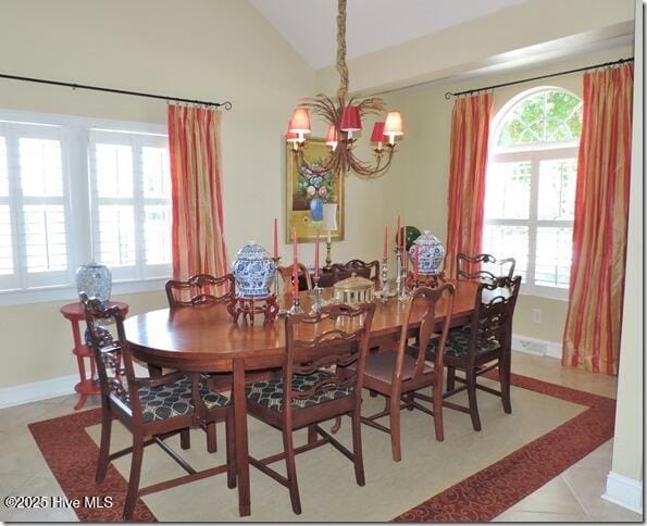 110 E Blalock Rd, Lucama, NC 27851 - tiled dining area with a chandelier, vaulted ceiling, and baseboards