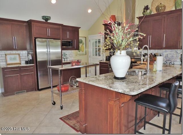 110 E Blalock Rd, Lucama, NC 27851 - kitchen featuring appliances with stainless steel finishes, tasteful backsplash, a sink, a peninsula, and lofted ceiling