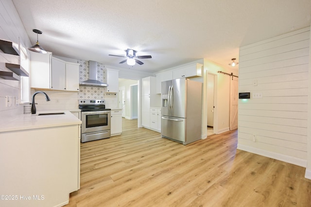159 Dockside Dr, Jacksonville, NC 28546 - kitchen with stainless steel appliances, wall chimney range hood, a sink, ceiling fan, and white cabinets