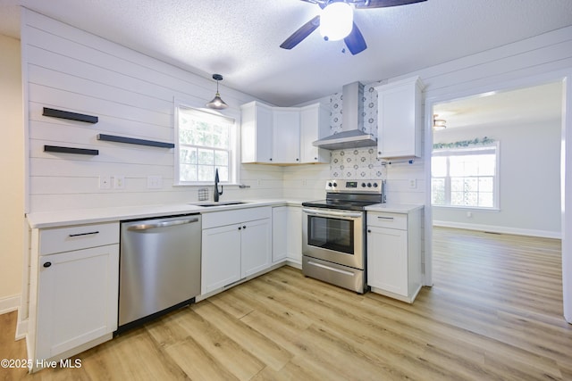 159 Dockside Dr, Jacksonville, NC 28546 - kitchen with appliances with stainless steel finishes, wall chimney exhaust hood, a sink, light wood-type flooring, and backsplash
