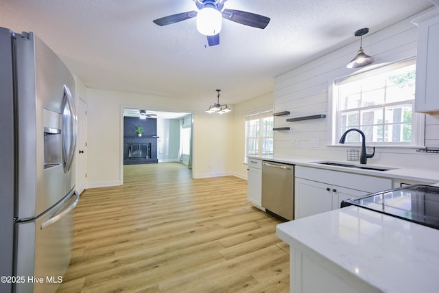 159 Dockside Dr, Jacksonville, NC 28546 - kitchen with stainless steel appliances, ceiling fan, a sink, light countertops, and a textured ceiling