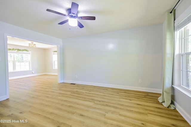 159 Dockside Dr, Jacksonville, NC 28546 - unfurnished room with light wood-style floors, a ceiling fan, baseboards, and a textured ceiling