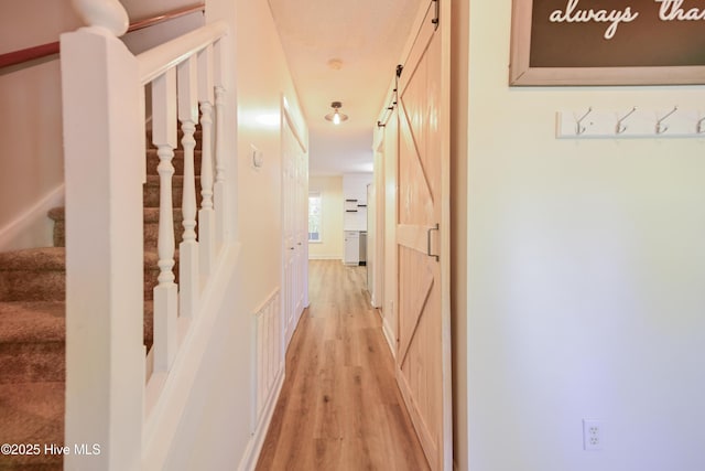 159 Dockside Dr, Jacksonville, NC 28546 - corridor featuring light wood-type flooring, a barn door, and stairs