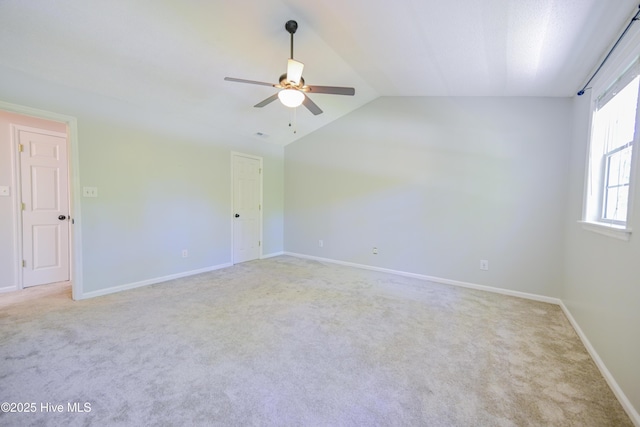 159 Dockside Dr, Jacksonville, NC 28546 - empty room with a ceiling fan, light colored carpet, vaulted ceiling, and baseboards