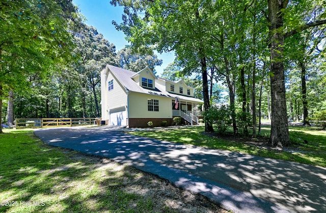 159 Dockside Dr, Jacksonville, NC 28546 - view of property exterior with driveway, a garage, stairway, covered porch, and view of wooded area
