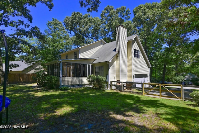 159 Dockside Dr, Jacksonville, NC 28546 - back of property featuring a sunroom, a garage, and a chimney