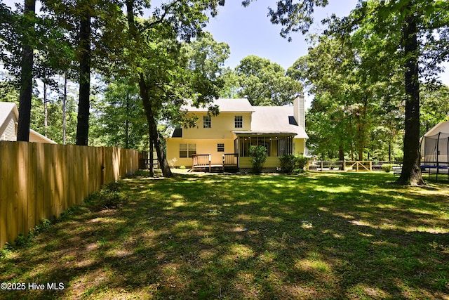 159 Dockside Dr, Jacksonville, NC 28546 - view of yard featuring a trampoline, a sunroom, and a deck
