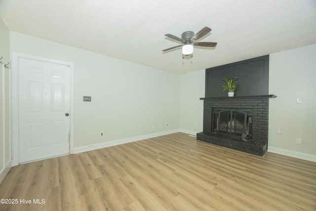159 Dockside Dr, Jacksonville, NC 28546 - unfurnished living room with light wood-style flooring, a ceiling fan, baseboards, and a fireplace