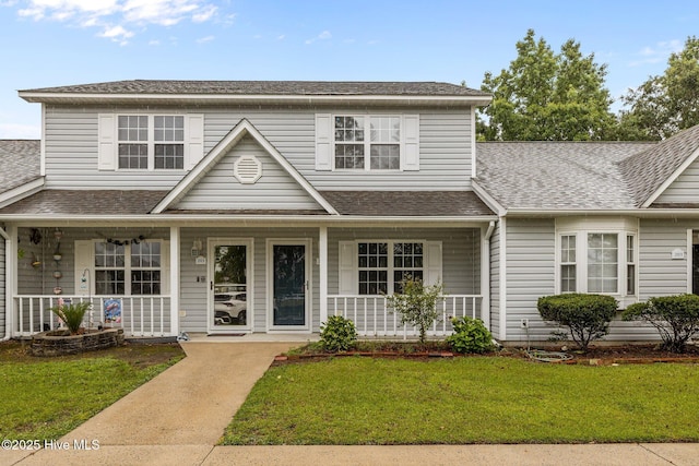 202 Courtyard W, Newport, NC 28570 - traditional-style home with a porch, a shingled roof, and a front lawn