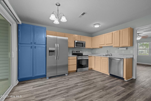 202 Courtyard W, Newport, NC 28570 - kitchen featuring stainless steel appliances, light brown cabinetry, light countertops, dark wood finished floors, and a textured ceiling