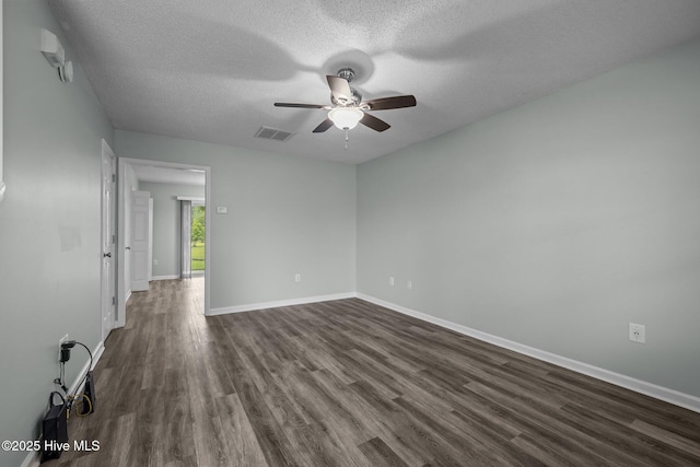 202 Courtyard W, Newport, NC 28570 - spare room with dark wood-style flooring, ceiling fan, and a textured ceiling