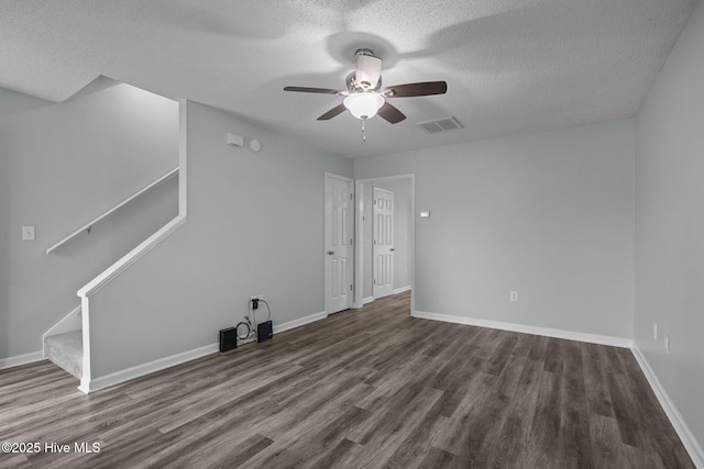 202 Courtyard W, Newport, NC 28570 - unfurnished room with ceiling fan, dark wood-type flooring, a textured ceiling, and stairway