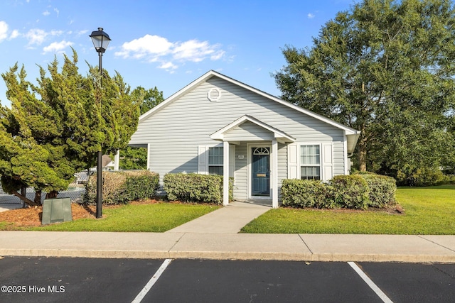 202 Courtyard W, Newport, NC 28570 - view of front facade with uncovered parking and a front lawn