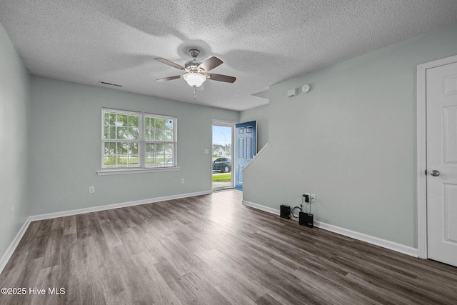 202 Courtyard W, Newport, NC 28570 - unfurnished living room with ceiling fan, wood finished floors, and a textured ceiling