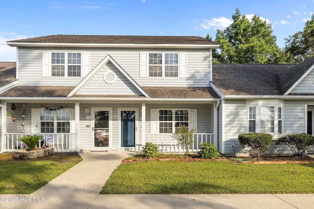 202 Courtyard W, Newport, NC 28570 - traditional-style house with a porch, a front lawn, and roof with shingles