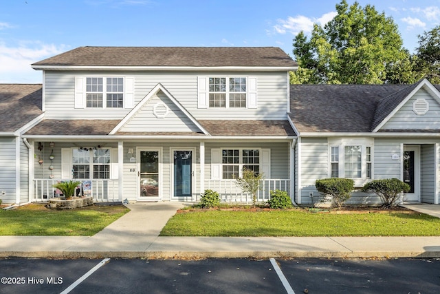 202 Courtyard W, Newport, NC 28570 - traditional-style house featuring a porch, uncovered parking, and a front lawn